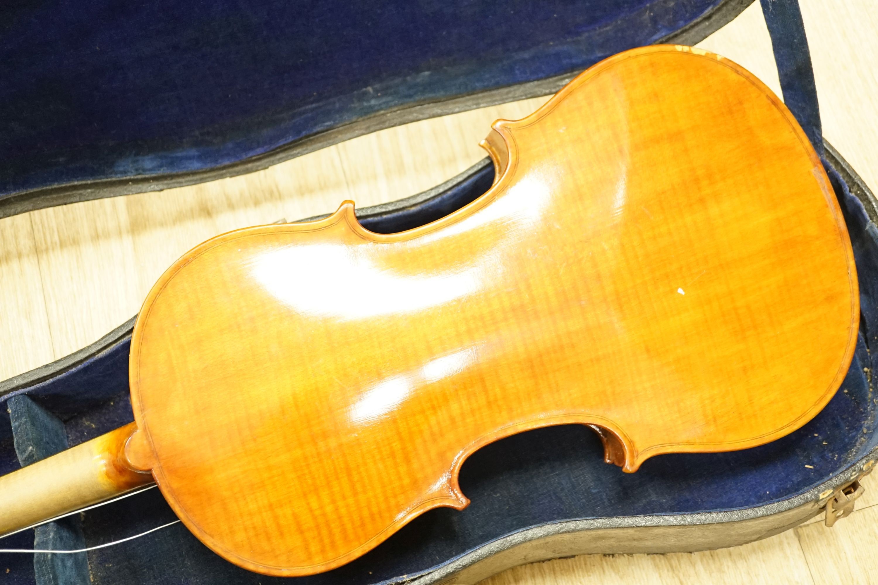 A cased violin, 60 cms long.